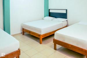 Habitación con 2 camas individuales en Hotel Quiam en Playa del Carmen