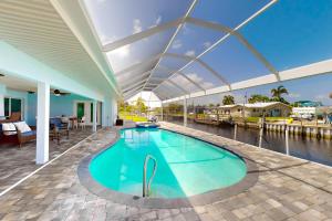 a swimming pool on a house with a roof at Hip Harbour in North Fort Myers