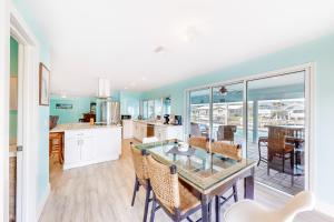 a kitchen and dining room with a table and chairs at Hip Harbour in North Fort Myers