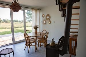 a dining room with a table and chairs at Szurmiejówka in Mieroszyno
