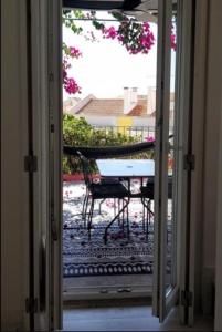 an open door to a patio with a table at Tings Lisbon in Lisbon