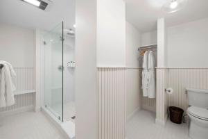 uma casa de banho branca com um chuveiro e um WC. em The Davenport Inn em Portsmouth