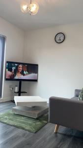 a living room with a flat screen tv on a wall at Luxury apartment in dudley in West Bromwich
