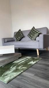 a living room with a couch and a rug at Luxury apartment in dudley in West Bromwich