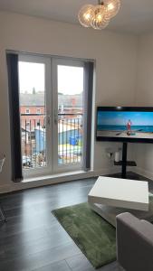 a living room with a couch and a large window at Luxury apartment in dudley in West Bromwich