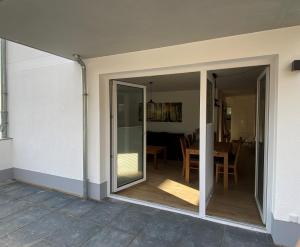 a sliding glass door leading to a patio with a table at Klönhüsing in Altefähr