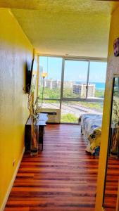 a bedroom with a bed and a view of the ocean at Soothing Hawaii Condo - 18F in Honolulu