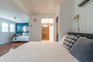 a bedroom with a bed and a room with a door at Downtown Studio 2 at Beer Ranch Project Inn in Wimberley