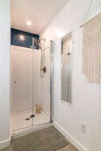a bathroom with a shower with a glass door at Downtown Studio 2 at Beer Ranch Project Inn in Wimberley