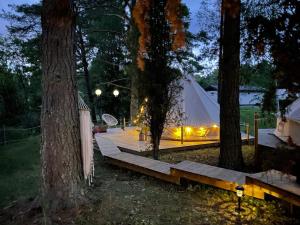 a tent is set up in the woods at night at tent romantica a b&b in a luxury glamping style in Mariefred