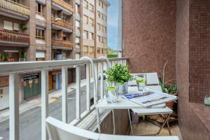 a balcony with a table and a newspaper on it at Apto Lourmar El Berrón in Berrón