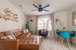 a living room with a couch and a ceiling fan at Downtown Lonestar Bungalow at Beer Ranch Project in Wimberley