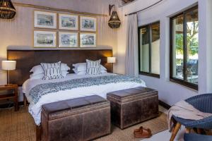 a bedroom with a large bed with a wooden headboard at Simbavati Amani in Klaserie Private Nature Reserve