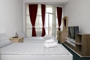Postel nebo postele na pokoji v ubytování Hotel Xhema