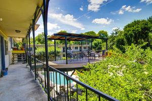 a balcony with a table and chairs and an umbrella at South River Condo in Austin