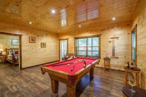 a pool table in a room with wooden walls at The Honeycomb Hideaway in Sevierville