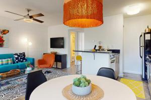 a living room with a table and a kitchen at South River Condo in Austin