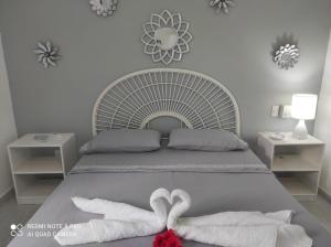 a bedroom with a bed with two heart towels at Villa Preciosa in Bayahibe