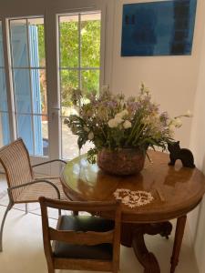 a table with a vase of flowers on top of it at La naronne in Bandol
