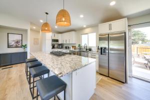 a kitchen with a large island with bar stools at Modern Del Rey Oaks Retreat 2 Mi to Monterey Bay! in Del Rey Oaks