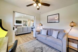 a living room with a couch and a ceiling fan at Modern Del Rey Oaks Retreat 2 Mi to Monterey Bay! in Del Rey Oaks