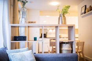 a living room with a couch and a table with vases on it at Magnificent Two Bedroom Apartment - SD23M in Eindhoven