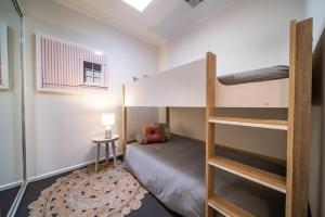 a bedroom with a bunk bed with a ladder at Black Oak at Brompton in Bowden