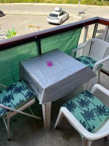 a table and two chairs sitting on a balcony at Combettes Studio Apartment in Les Contamines-Montjoie