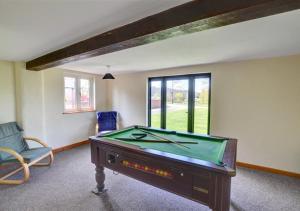 a room with a pool table in a room at Y Beudy in Llandinam