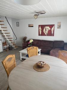 a living room with a table and a couch at Nordwind Sjut in Warnow