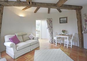 a living room with a couch and a table at Sampson's Mill in Wickham Market