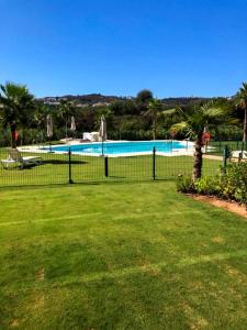 a black fence in front of a swimming pool at Luxury La Cala Golf Retreat with terrace & pool in La Cala de Mijas