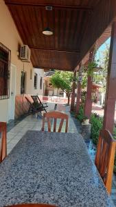a patio with a table and chairs on a porch at Hospedagem Serra da Lua in Alter do Chao