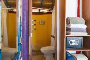 a small bathroom with a toilet and a sink at El Secreto Xpuha in Xpu Ha