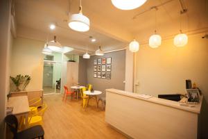 a restaurant with tables and chairs and a counter at Micro Hostel in Bangkok