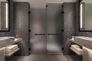 a bathroom with two sinks and a glass door at The Ritz-Carlton New York, NoMad in New York