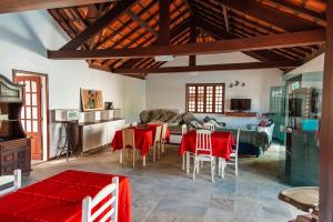 a living room with a table and chairs and a couch at Mansão Residence & Club in Vassouras