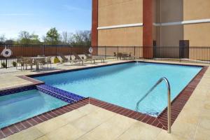 a large swimming pool in front of a building at Four Points by Sheraton Houston Hobby Airport in Houston