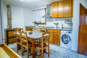 a kitchen with a table and chairs in a kitchen at Casa da Ernesta in Mondim de Basto