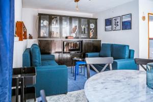 a living room with blue chairs and a table at Casa da Ernesta in Mondim de Basto