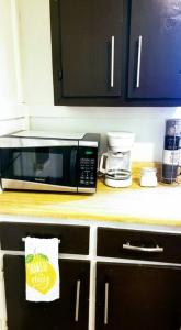a microwave sitting on top of a kitchen counter at Contactless Entry Casino's/ Plants Workers in Lake Charles