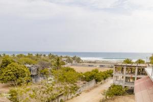 a view of the beach from the balcony of a building at Hotel VidaMar in Puerto Escondido