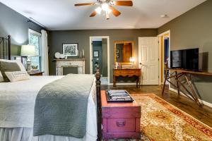 a bedroom with a bed with a ceiling fan and a tv at Dog-Friendly Dahlonega Home with Private Fire Pit! in Dahlonega