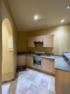 an empty kitchen with a sink and a stove at Palmeraie 3 Vue Piscine et Jardin in Marrakech