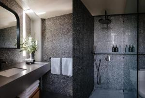 a bathroom with a shower and a sink at Colima 71 Art - Community - Hotel in Mexico City