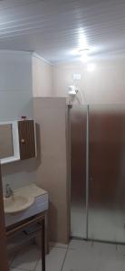a bathroom with a shower and a sink at Sitio Arco Iris da Lia in São Roque