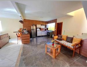 a living room with a couch and a table at Casa de Praia Pontal in Ilhéus +8 photos