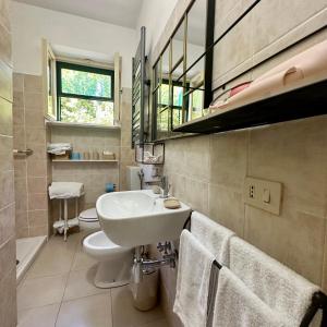 a bathroom with a sink and a toilet at Antica Fattoria La Parrina in Orbetello