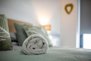 uma toalha branca deitada em cima de uma cama em Modern and Spacious Apartment in Salford Quays em Manchester