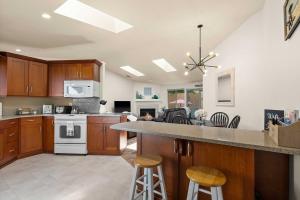 a large kitchen with wooden cabinets and a counter top at Cozy Tacoma Home with Patio, Walk to Beach! in Tacoma
